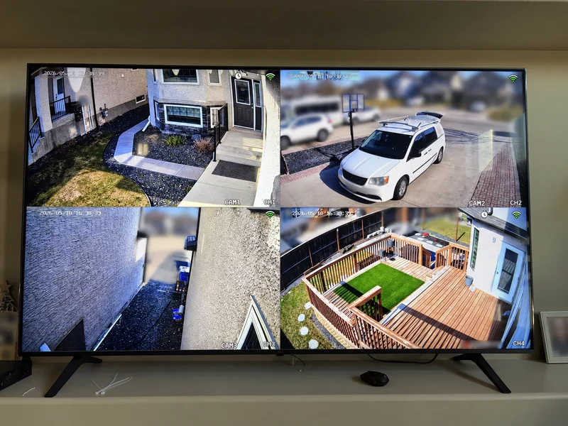 Real TDD security camera project: entrance, driveway, side passage and backyard views together on a TV, with original timestamps visible and private details blurred