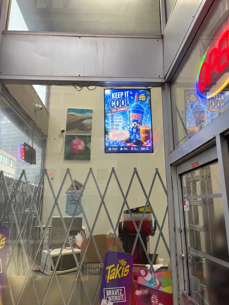 Window-mounted LED lightbox displaying a summer drinks promotion in Winnipeg